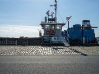 a cargo ship docked at the dock on a sunny day with a blue sky in the background