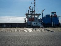 a cargo ship docked at the dock on a sunny day with a blue sky in the background