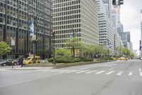 cars driving on the street in front of skyscrapers in the city by the streets with flowers