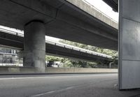 cars driving under an overpass of an urban city area to avoid approaching traffic with other vehicles traveling