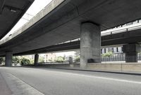 cars driving under an overpass of an urban city area to avoid approaching traffic with other vehicles traveling