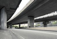 cars driving under an overpass of an urban city area to avoid approaching traffic with other vehicles traveling