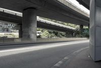 cars driving under an overpass of an urban city area to avoid approaching traffic with other vehicles traveling