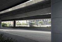 cars driving under an overpass of an urban city area to avoid approaching traffic with other vehicles traveling