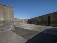 a large cement wall with doors on the side near the walls are exposed and concreteed