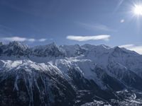 the sun is shining over snow - covered mountains and valley landscapes in winter,