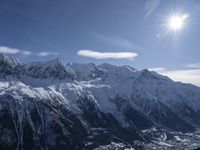 the sun is shining over snow - covered mountains and valley landscapes in winter,