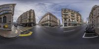 a fisheye lens is pictured of a street and a motor scooter parked at the intersection