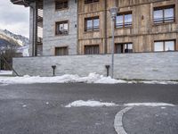 a sign is on the pavement outside a building in the middle of nowhere with snow all around