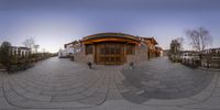 a circular photo of an exterior at sunset, and a house on the other side