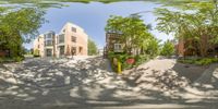 a full view of the street, from the perspective of a fish eye lens, shows houses and trees