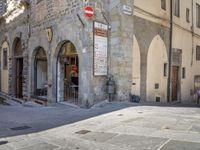 a street scene with focus on the sign that says the no entry way sign on the sidewalk