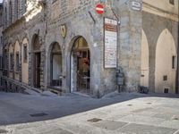 a street scene with focus on the sign that says the no entry way sign on the sidewalk