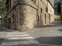 a street in an italian town where one has an umbrella over it and the other one has an umbrella over his head