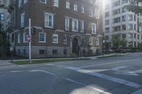 there is an empty street with buildings in the background and a stop sign for no entry