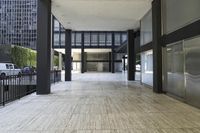 an empty walkway leading to an open area near the building's parking lot that is next to the street