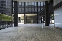 an empty walkway leading to an open area near the building's parking lot that is next to the street