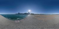 360 - pane fish eye view on the beach with buildings in the background with no clouds