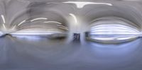 some white abstract shapes with long lines in a building ceiling in the rain storming sky