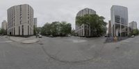 the street is empty in front of some buildings and lots of parking spaces to go through