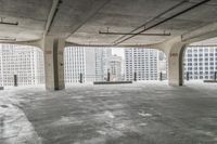 a room with no one on it and large columns, overlooking the city skyline as seen from inside