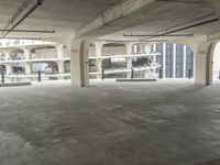 a room with no one on it and large columns, overlooking the city skyline as seen from inside