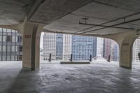 a room with no one on it and large columns, overlooking the city skyline as seen from inside