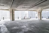 a room with no one on it and large columns, overlooking the city skyline as seen from inside