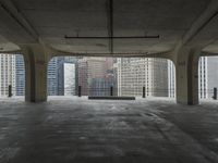 a room with no one on it and large columns, overlooking the city skyline as seen from inside