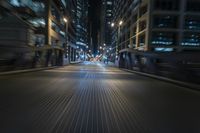 an empty city street during the night time with buildings in the background, blurredd and dark