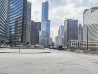 there is an empty parking lot in the city of chicago, where traffic and buses can be seen