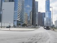 there is an empty parking lot in the city of chicago, where traffic and buses can be seen