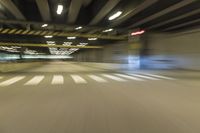 an image of nightlife inside of a city tunnel that is almost empty on the first floor