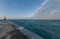 the ocean has been lined with some concrete posts that have been placed along it as seen in this photo