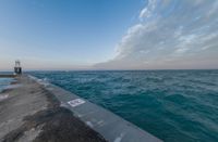 the ocean has been lined with some concrete posts that have been placed along it as seen in this photo