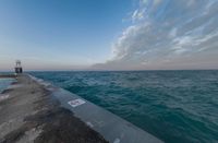 the ocean has been lined with some concrete posts that have been placed along it as seen in this photo