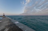 the ocean has been lined with some concrete posts that have been placed along it as seen in this photo