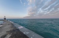 the ocean has been lined with some concrete posts that have been placed along it as seen in this photo