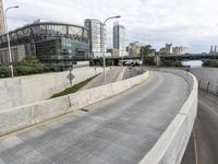 a long highway with a few bridges on it and cars driving down the street next to it