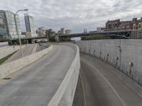 a long highway with a few bridges on it and cars driving down the street next to it