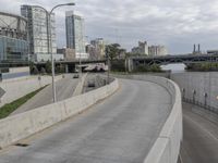 a long highway with a few bridges on it and cars driving down the street next to it