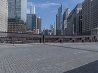 there is an empty sidewalk beside a street sign on the bridge in the city centre