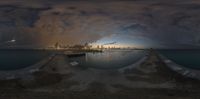 a panorama fisheye photo with a city in the back ground and the water below it