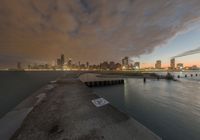 the skyline is lit up for night on the water's edge in the city