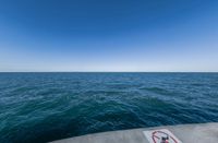 a concrete pier over looking the ocean on a clear day in late summer stock photo