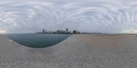 the view from one of three circular mirrors, one with a city skyline and another with clouds