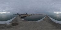 a 360 - view view from the sidewalk shows a body of water with boats floating around it