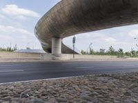 a freeway bridge going over an elevated highway and a bunch of gravel on the side