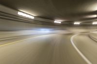 speeding through the tunnel on a highway in motion with blurry background, with light beam above it