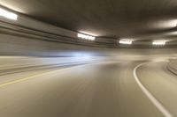 speeding through the tunnel on a highway in motion with blurry background, with light beam above it